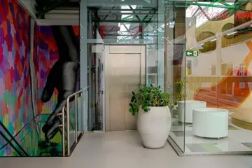 Elevador comercial em ambiente com arte urbana