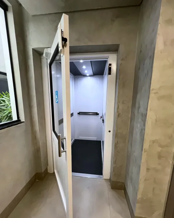 Elevador em hall com símbolo de acessibilidade na porta