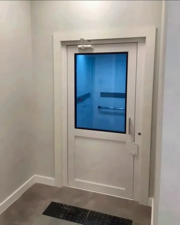 Porta de pavimento branca com visor de vidro e piso tátil à frente